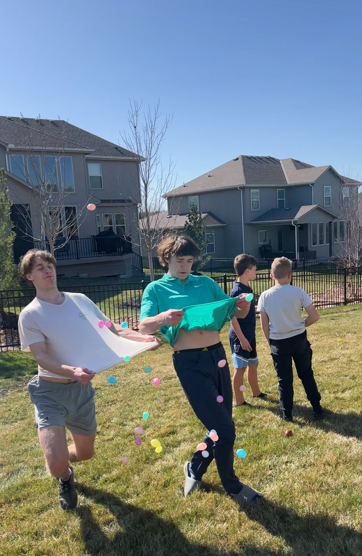 teens trying to catch eggs in their shirts