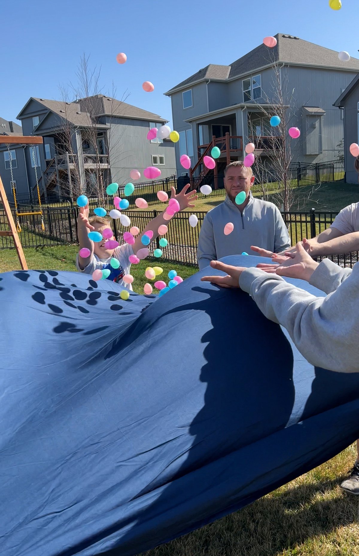 blue sheet with plastic eggs bouncing above it for an egg toss