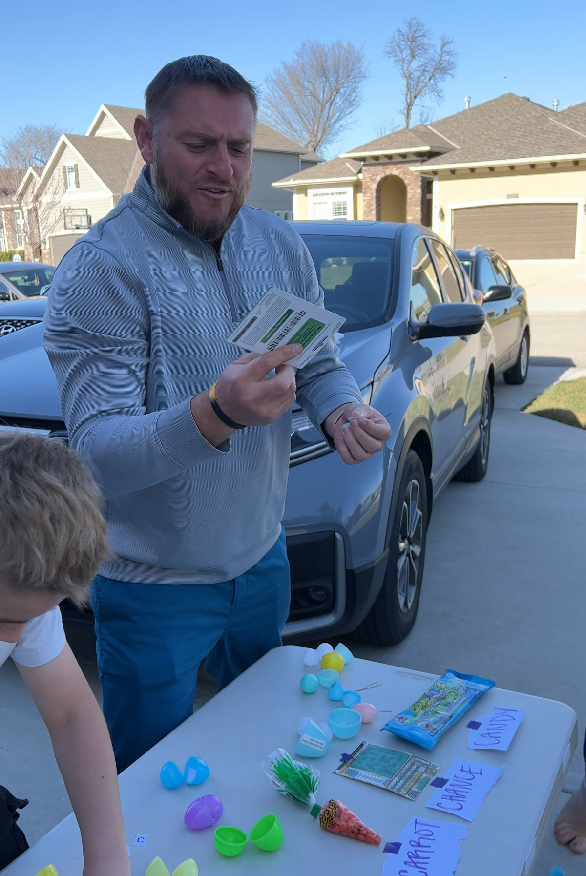 man holding a prize he won in an egg hunt