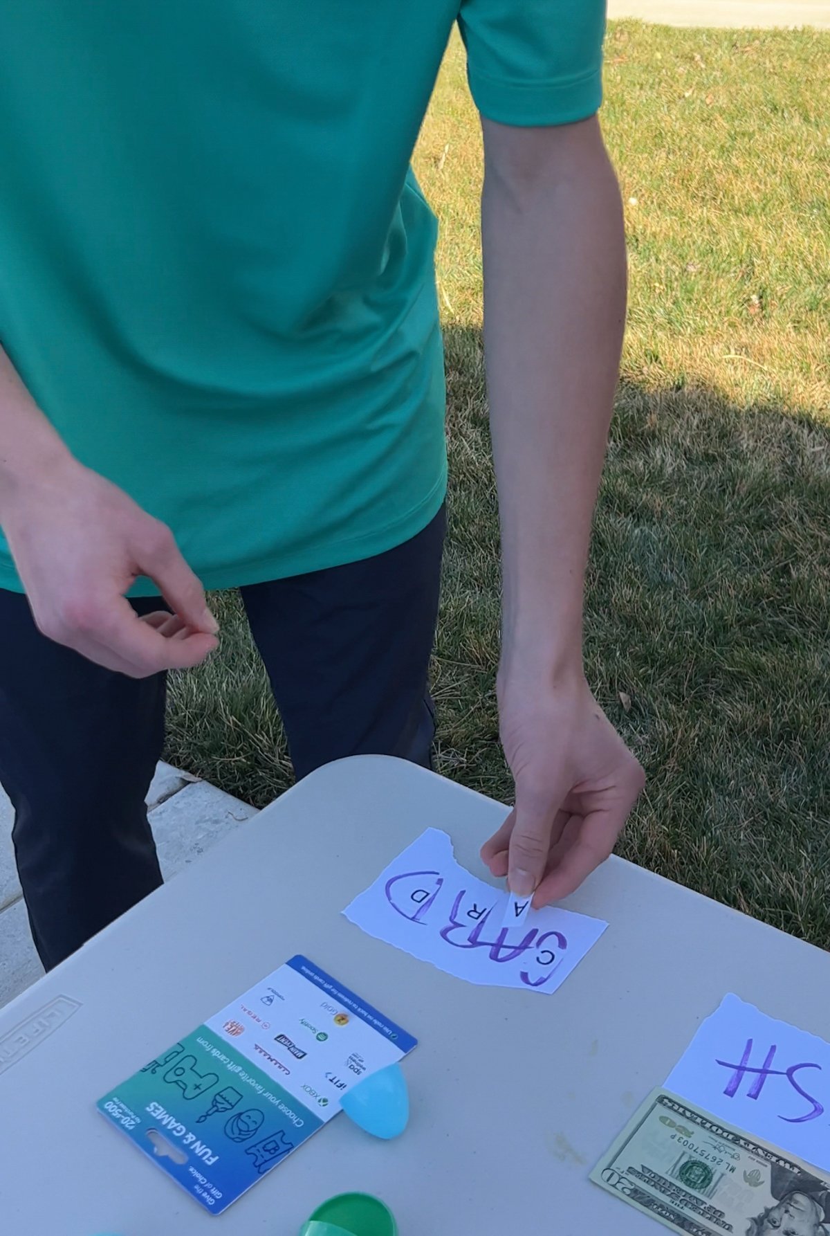 teen putting letters on a word on a table