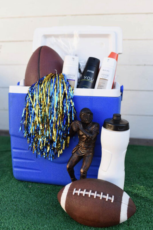 cooler filled with a. variety of football supplies