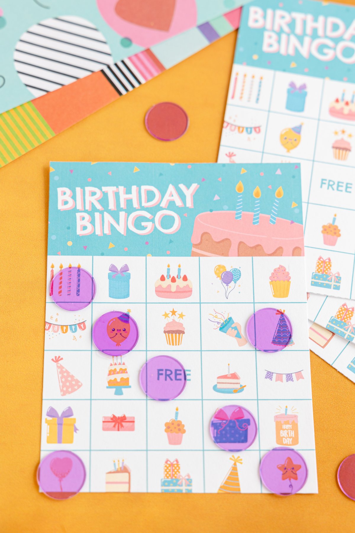 birthday bingo card with bingo markers on it