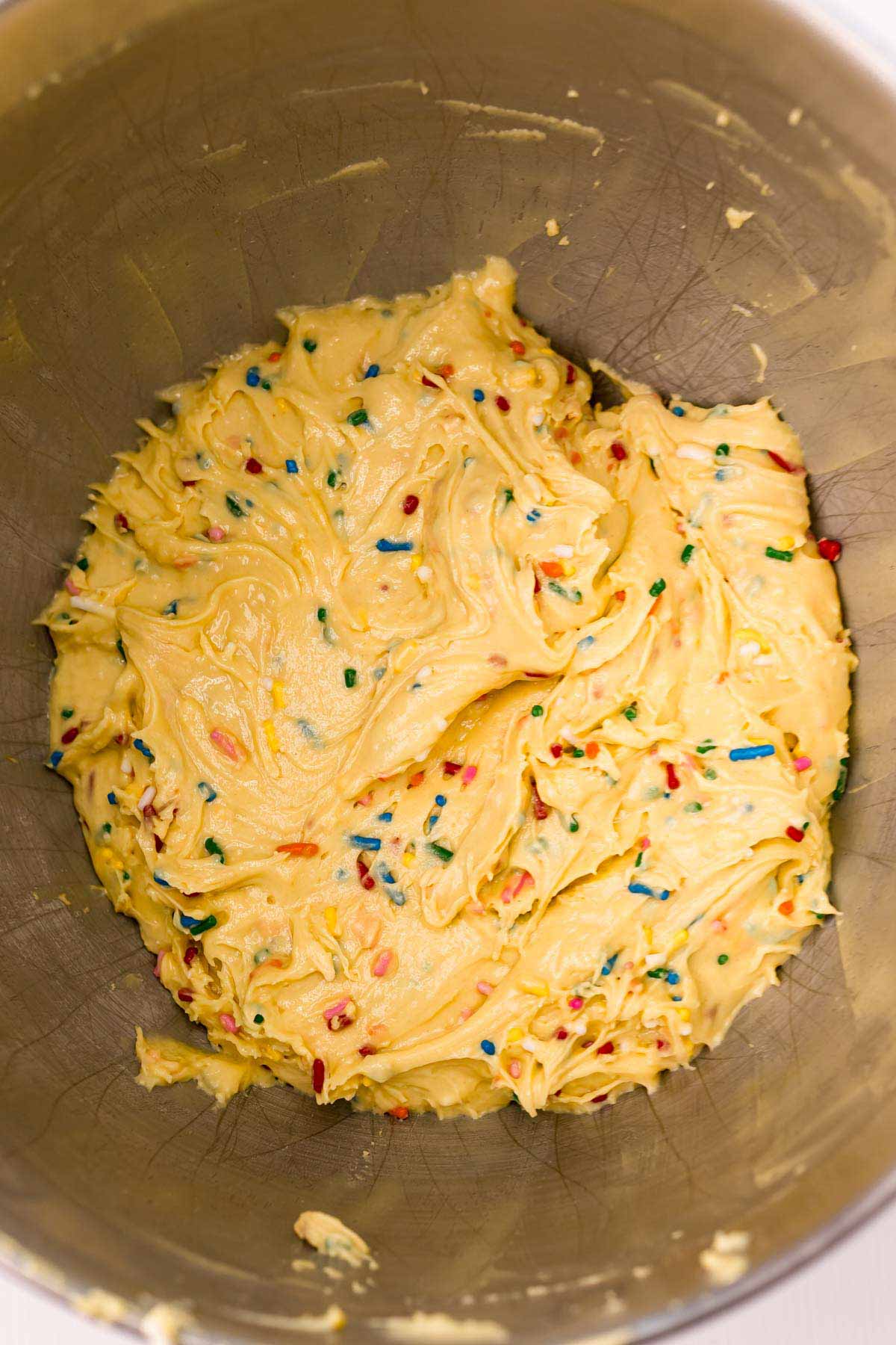 metal mixing bowl with batter for birthday cake blondies