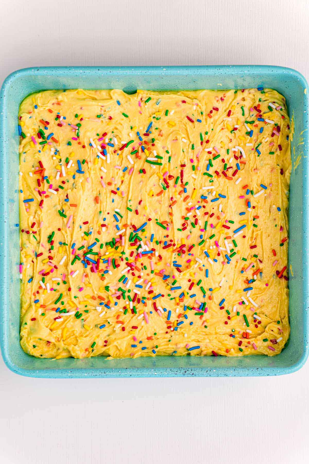 unbaked birthday cake blondies batter in a pan