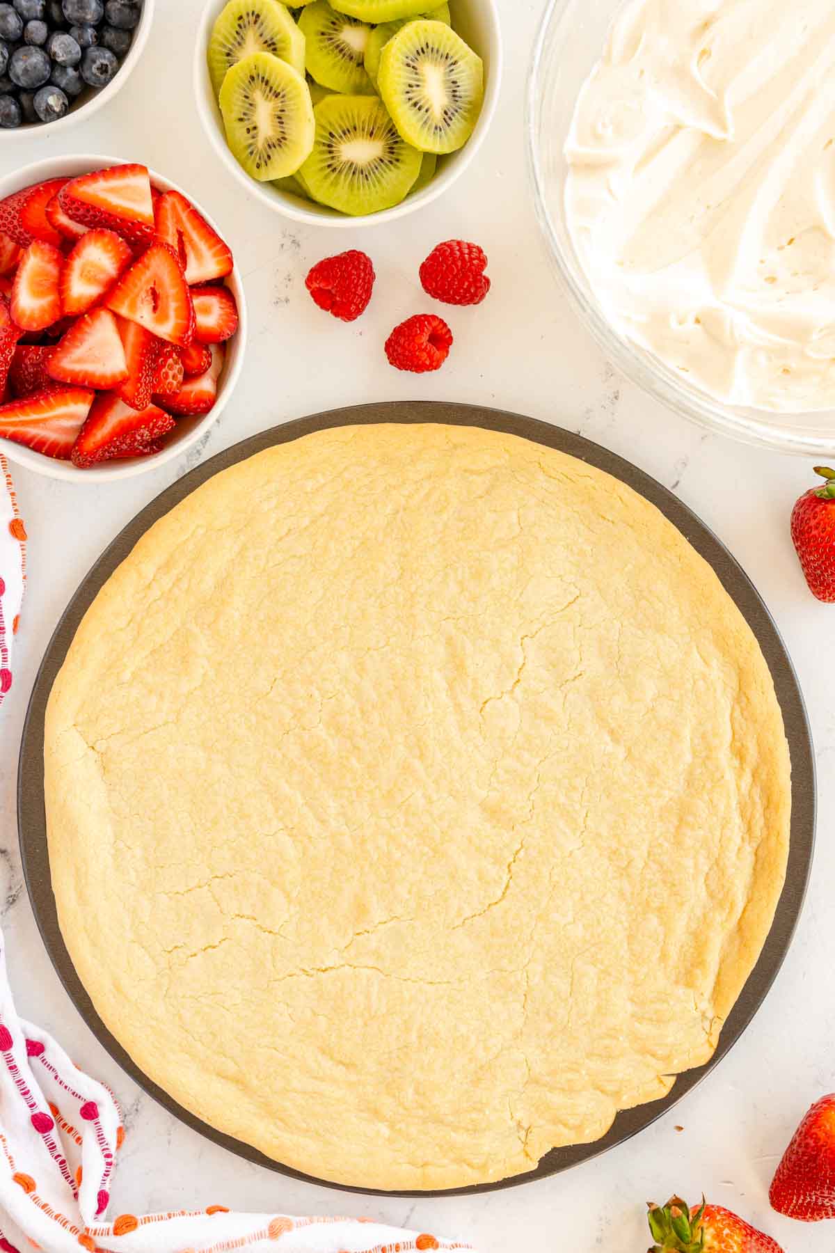 baked sugar cookie dough on a pizza pan