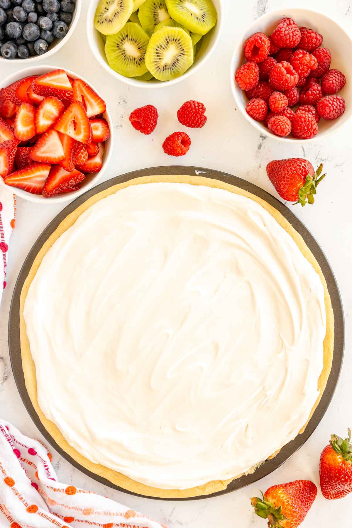 sugar cookie crust topped with cream cheese fruit pizza frosting