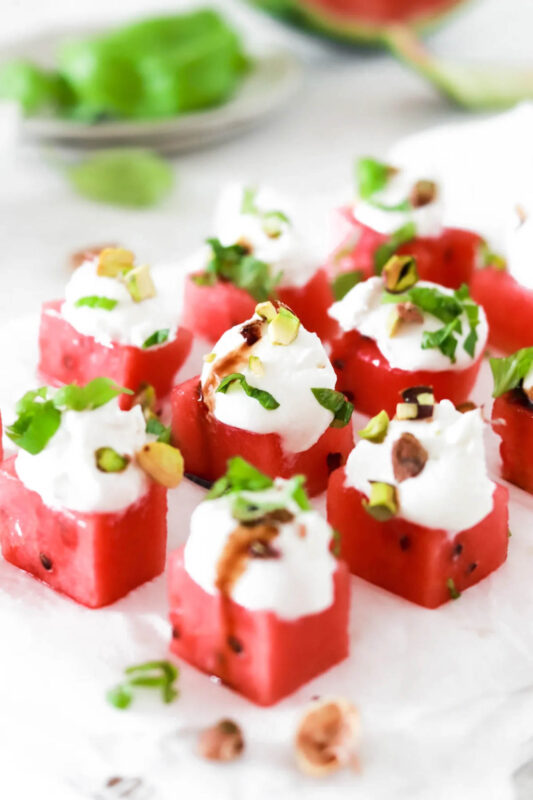 cubed watermelon bites topped with feta and pistachios