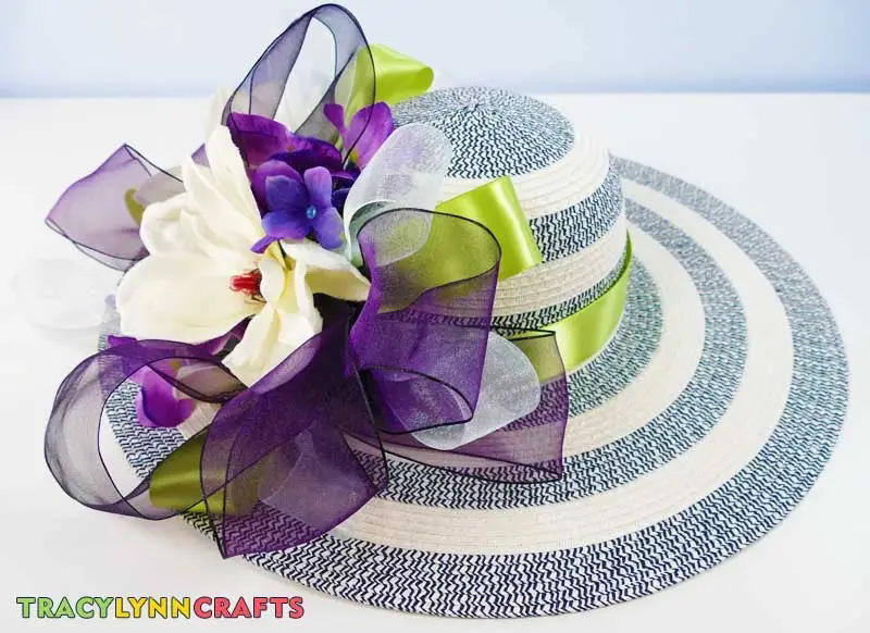 blue wide brim hat with purple ribbons and flowers
