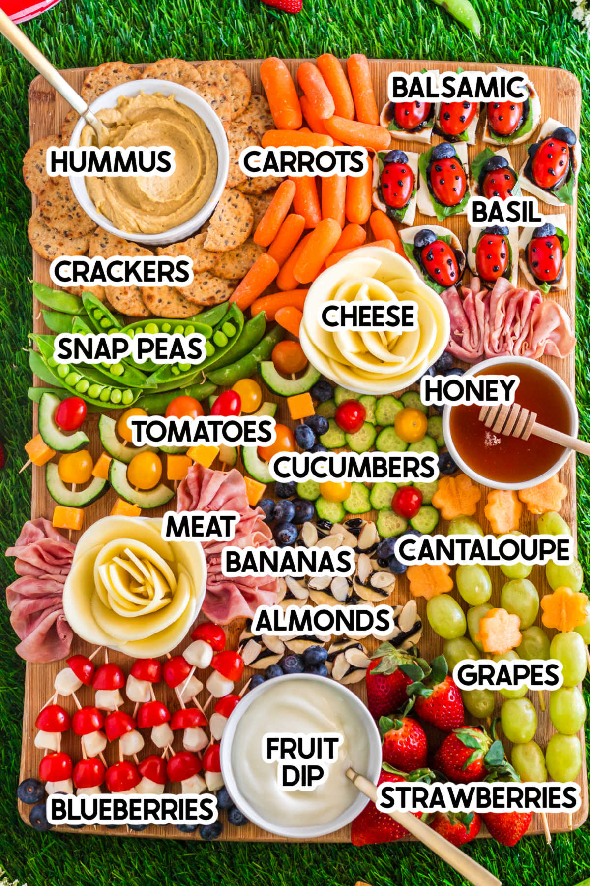picnic charcuterie board with ingredient labels on it