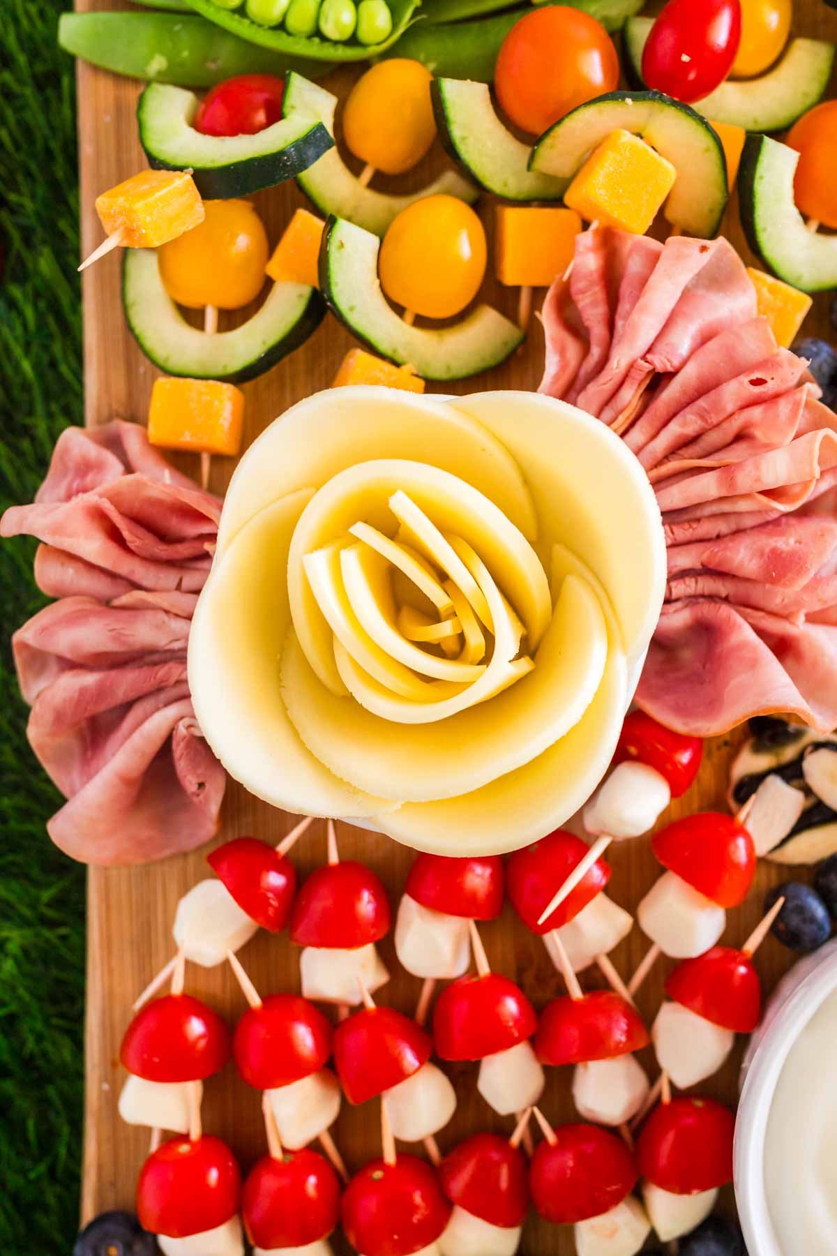 meat and cheese rose on a picnic charcuterie board