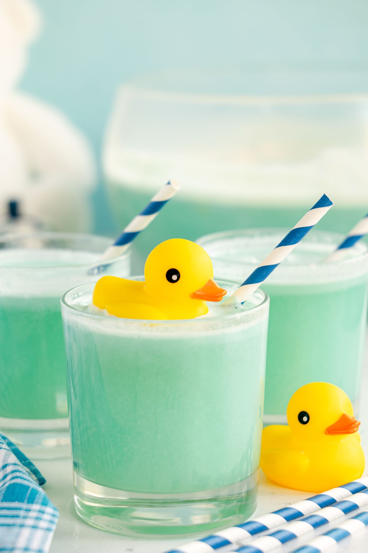 blue punch in a glass with a blue striped straw