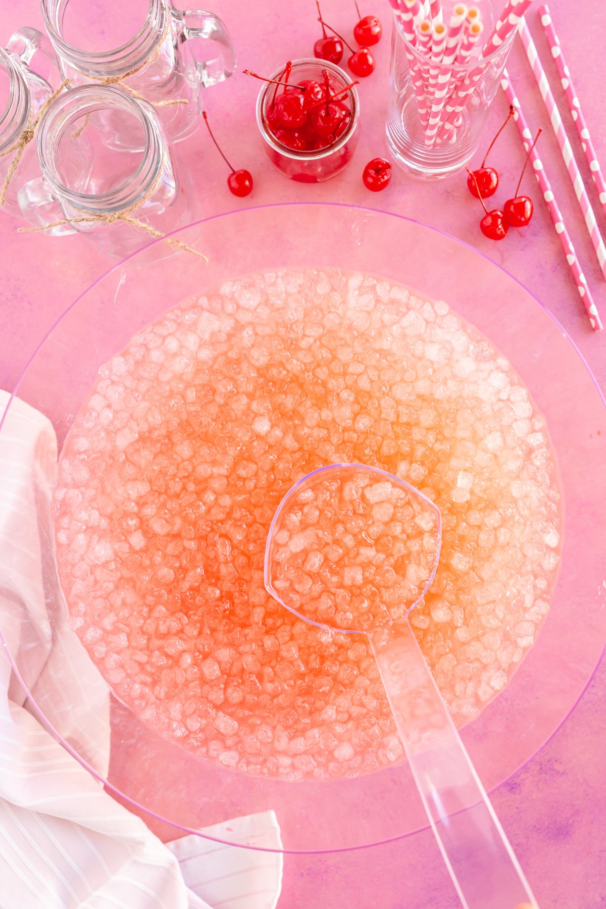 punch bowl filled with pink punch and ice