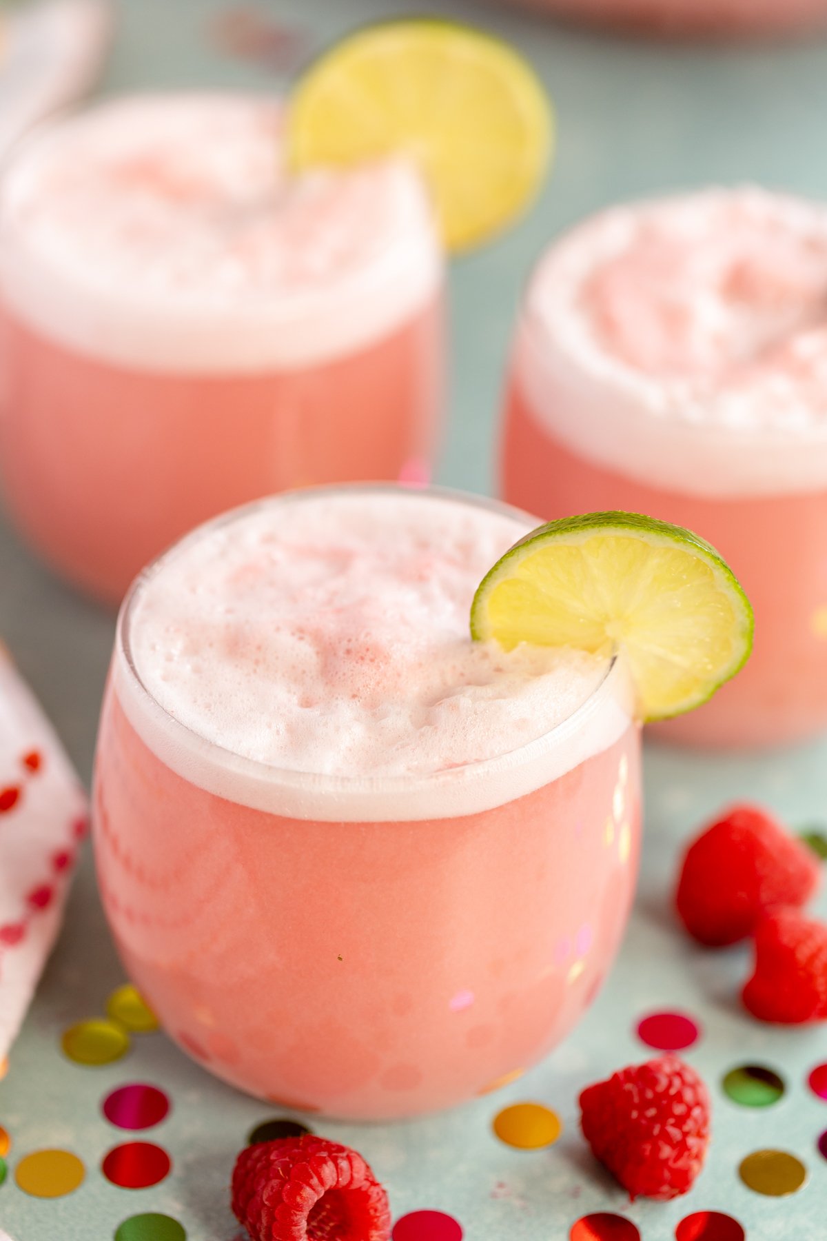 glasses of pink punch with lime wheel garnishes