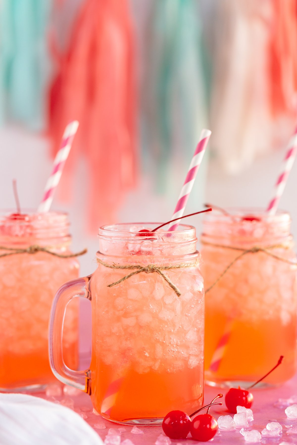 glasses of pink punch with straws sticking out