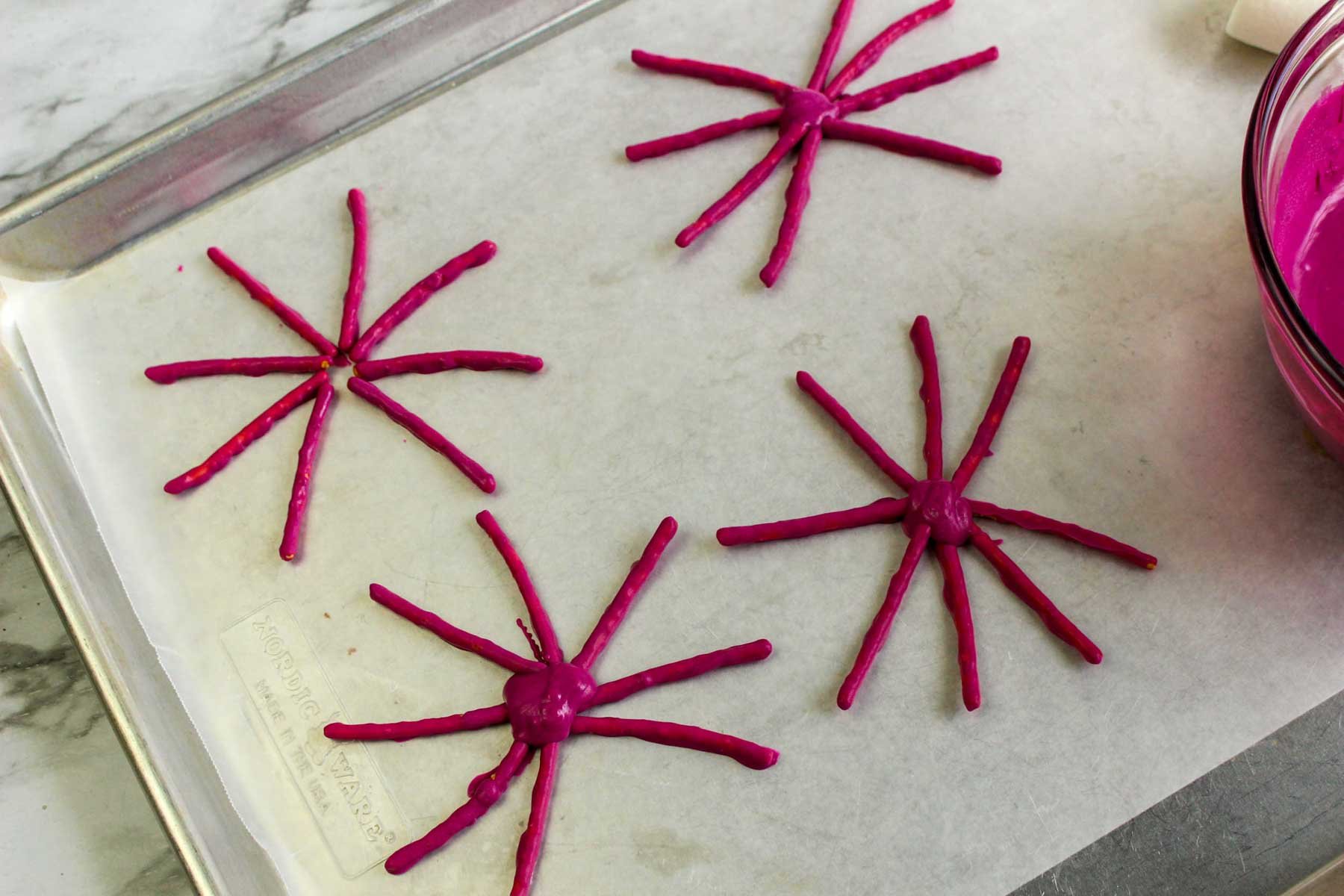 purple pretzels on a piece of wax paper