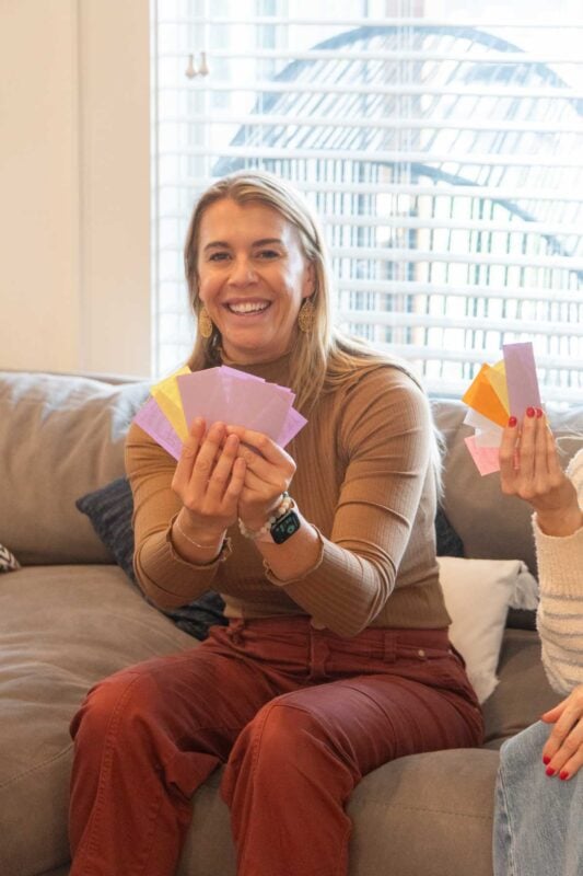 woman holding up a handful of play money