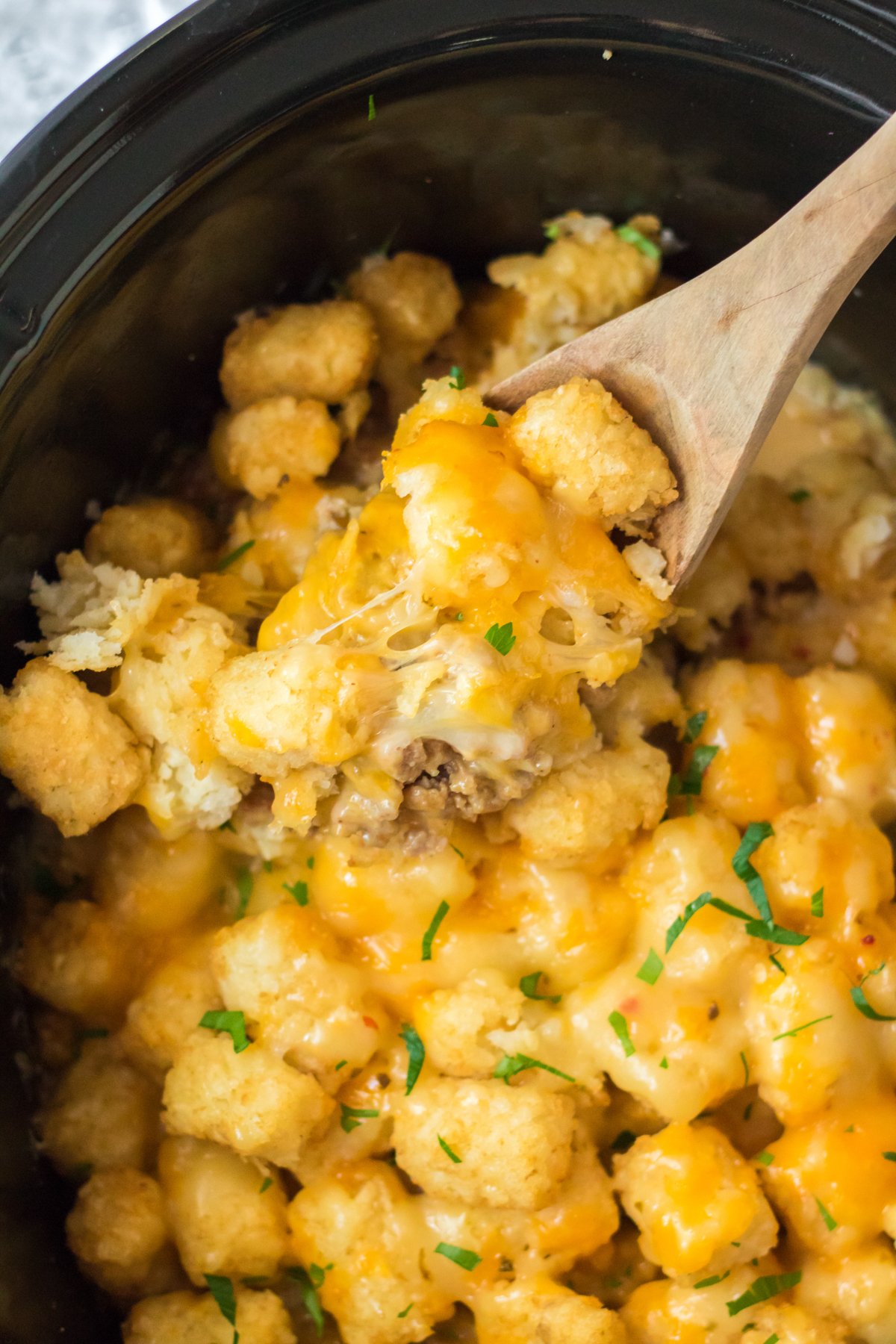 wooden spoon in a tater tot breakfast casserole
