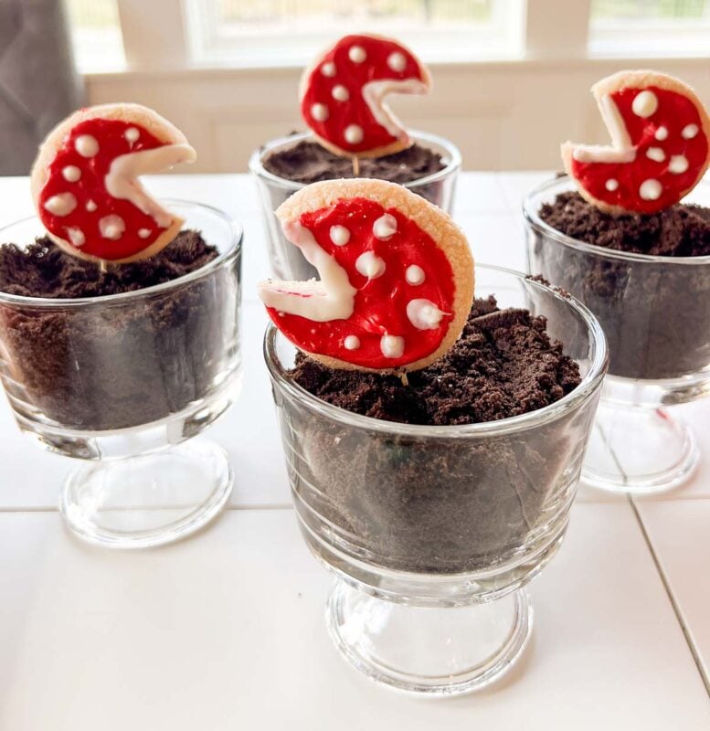 glass trifle dishes with Oreo dirt and pirahna cookies
