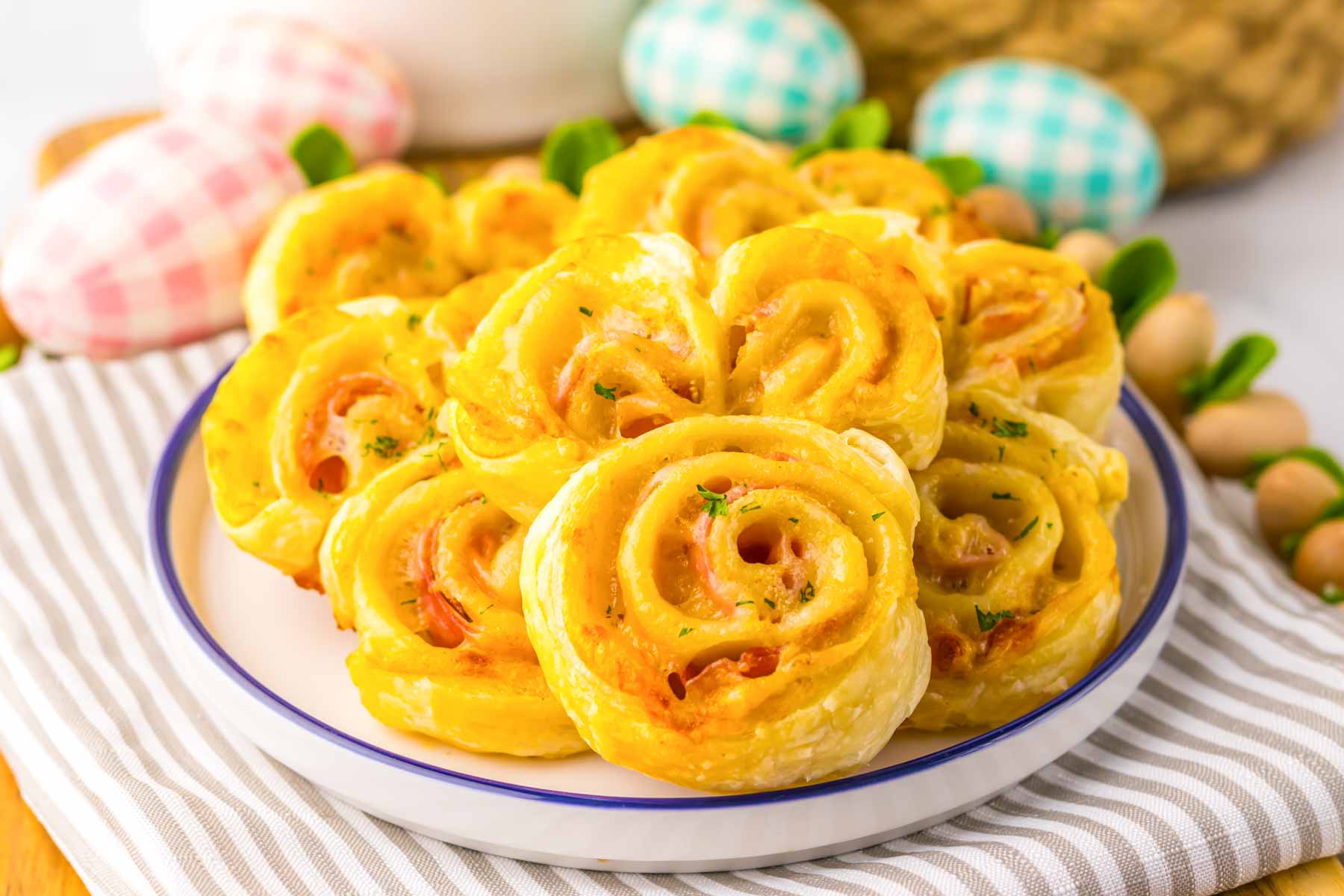 white plate with Easter ham and cheese appetizers in the shape of rabbits