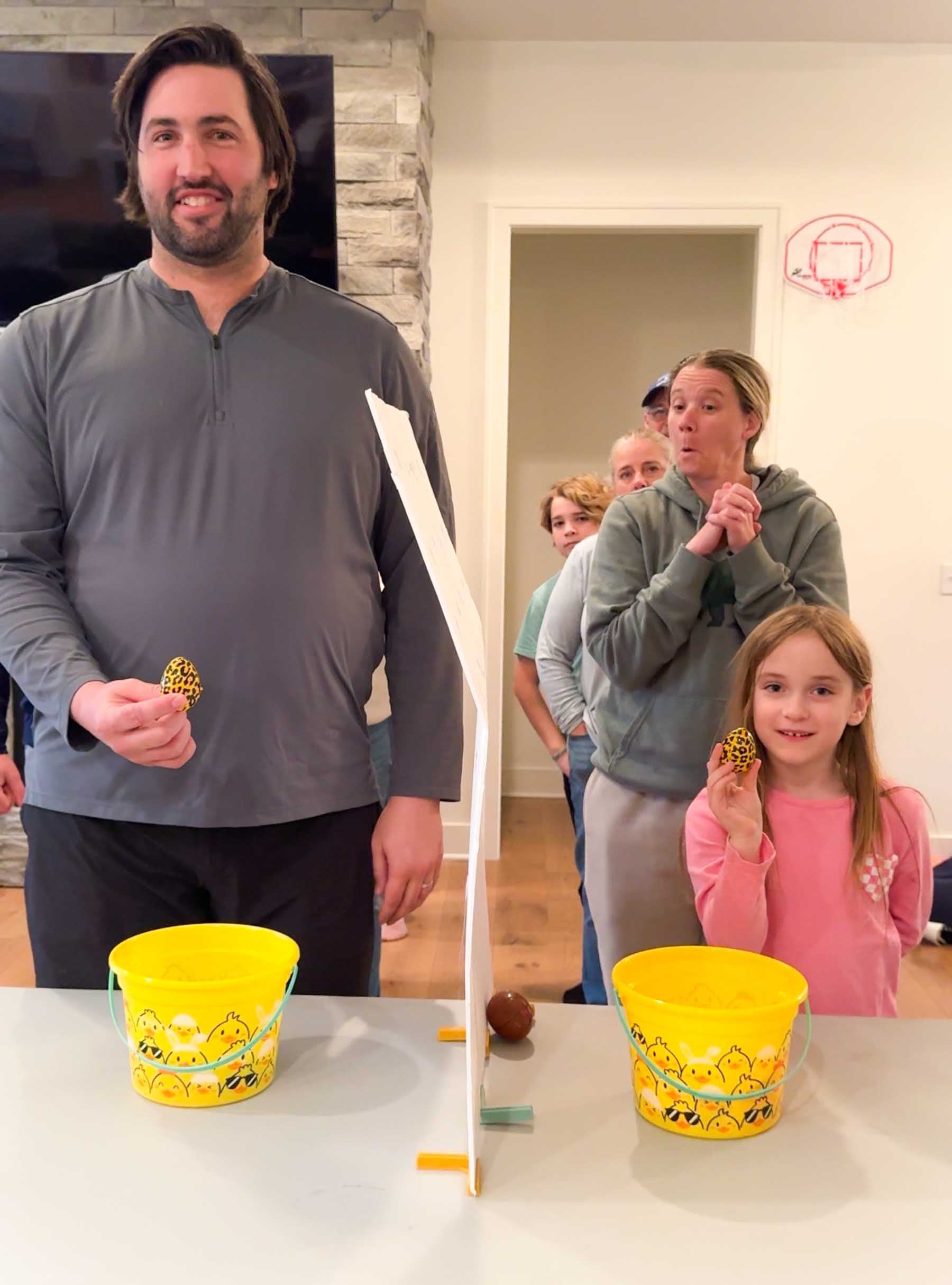 two people holding up matching eggs