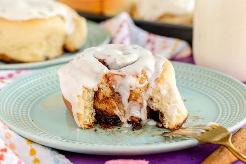 open homemade cinnamon roll on a blue plate