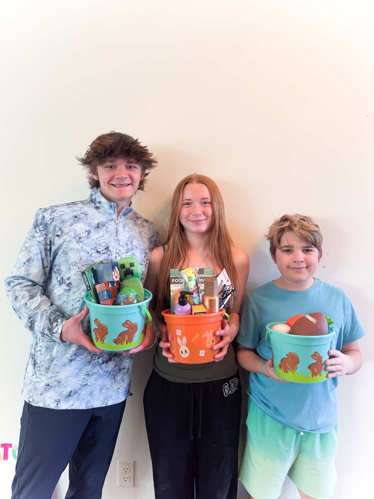 three teens holding Easter baskets