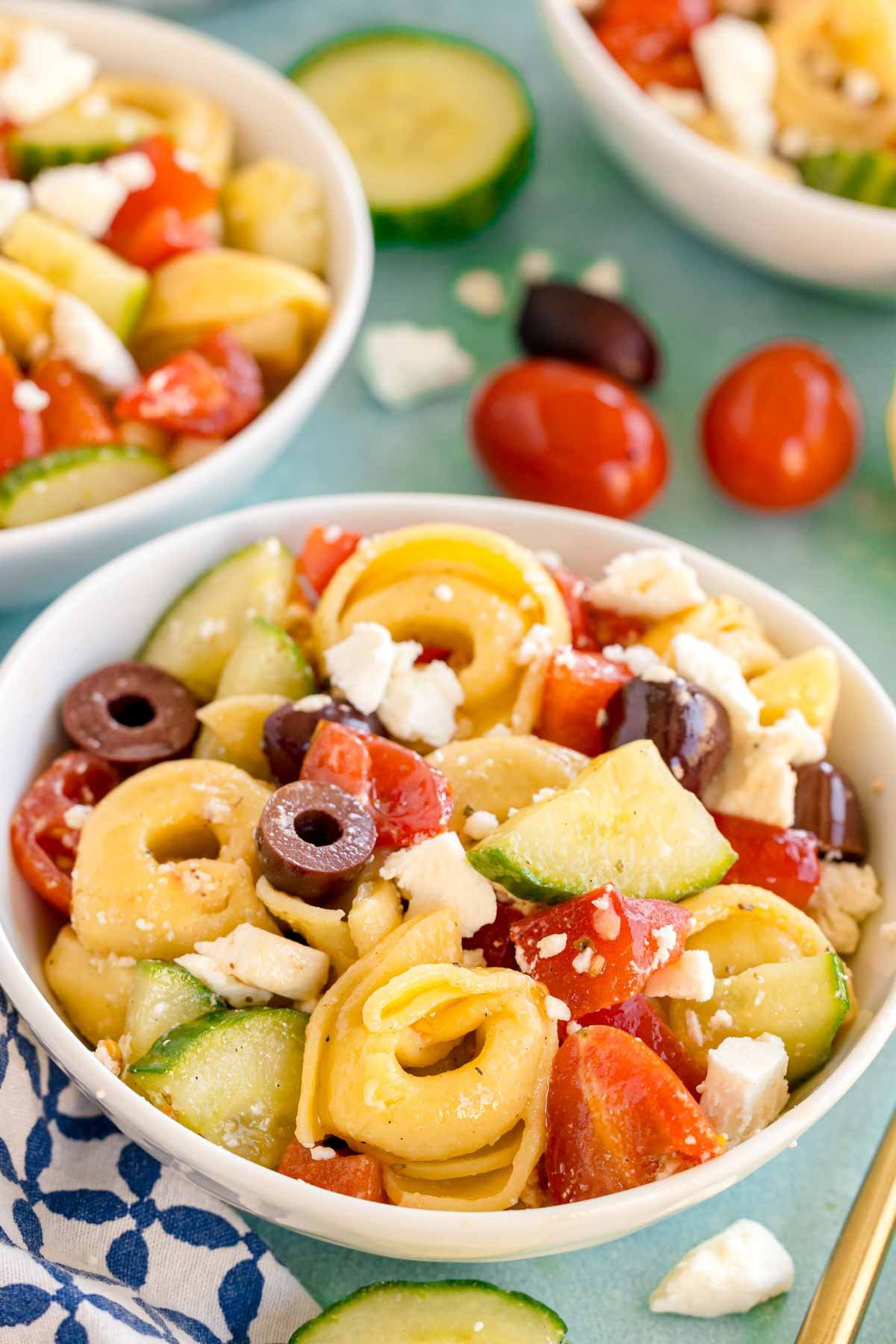 small white bowl of greek tortellini pasta salad
