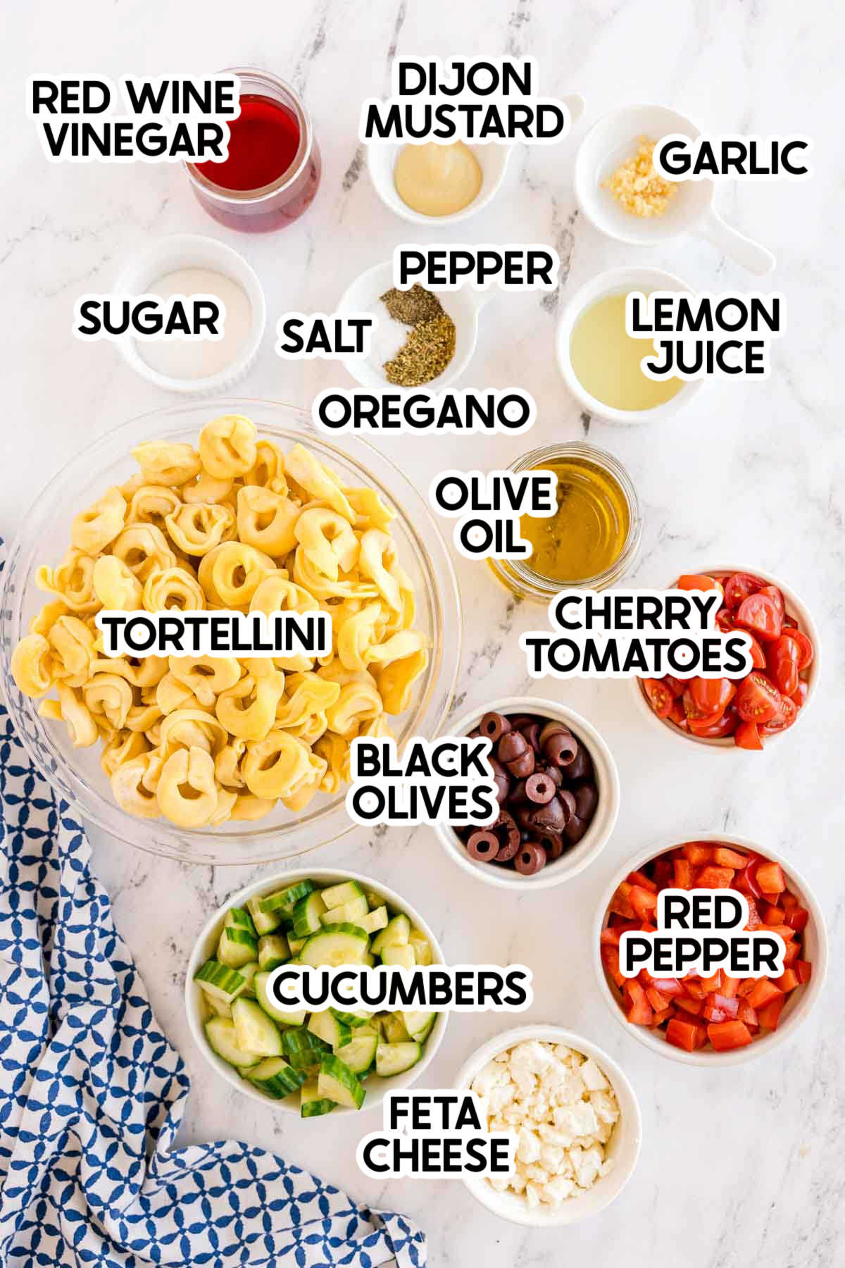 ingredients in a Greek tortellini pasta salad with labels