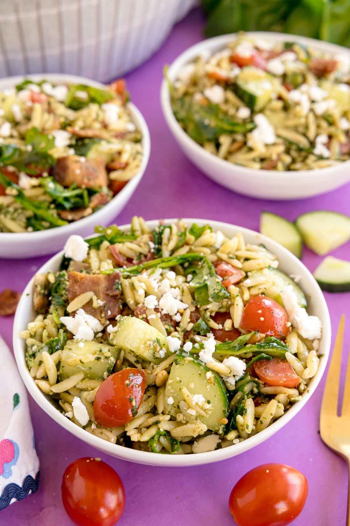 white bowl of pesto orzo salad 