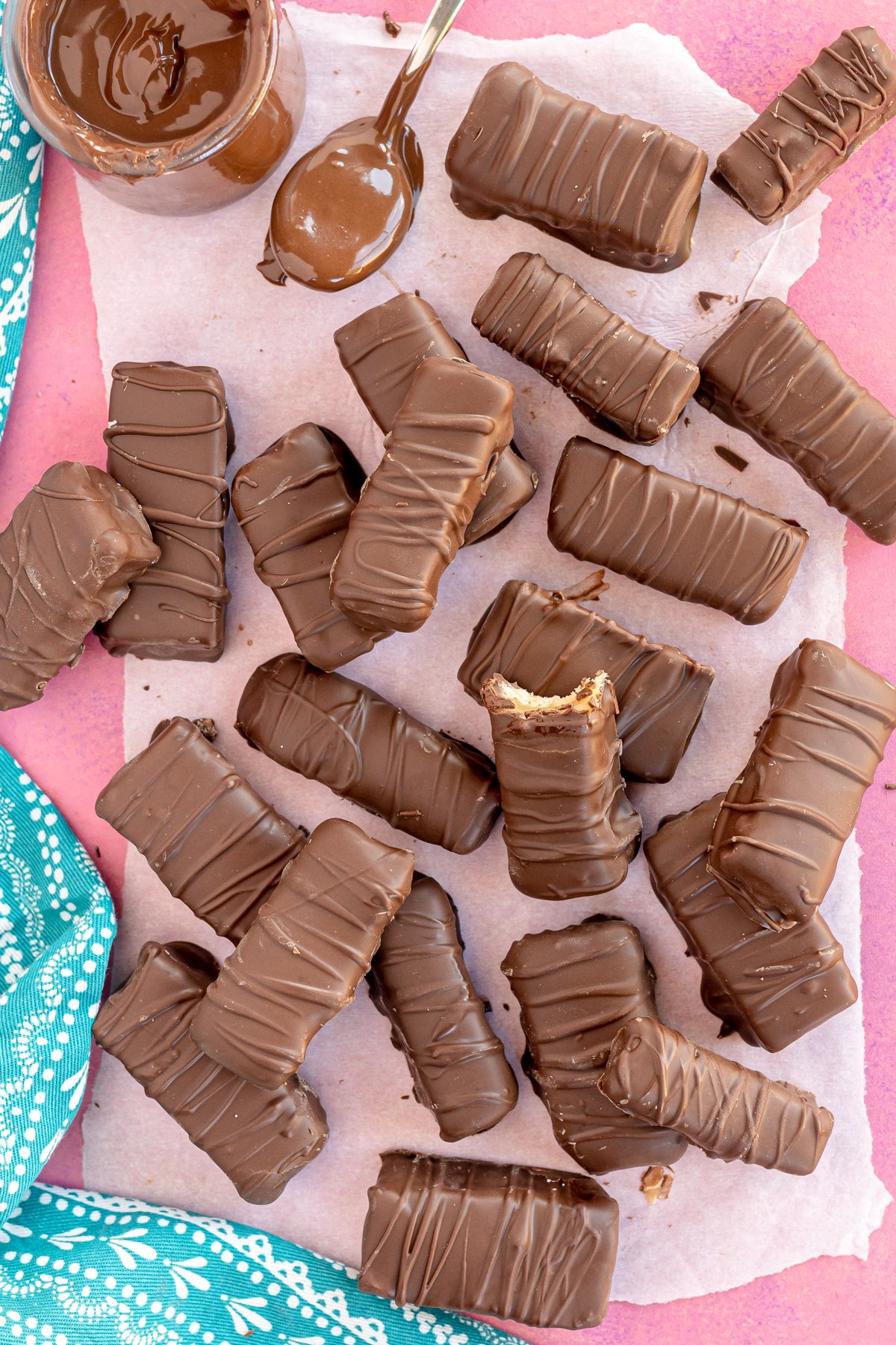 pile of homemade Twix bars with a pink background