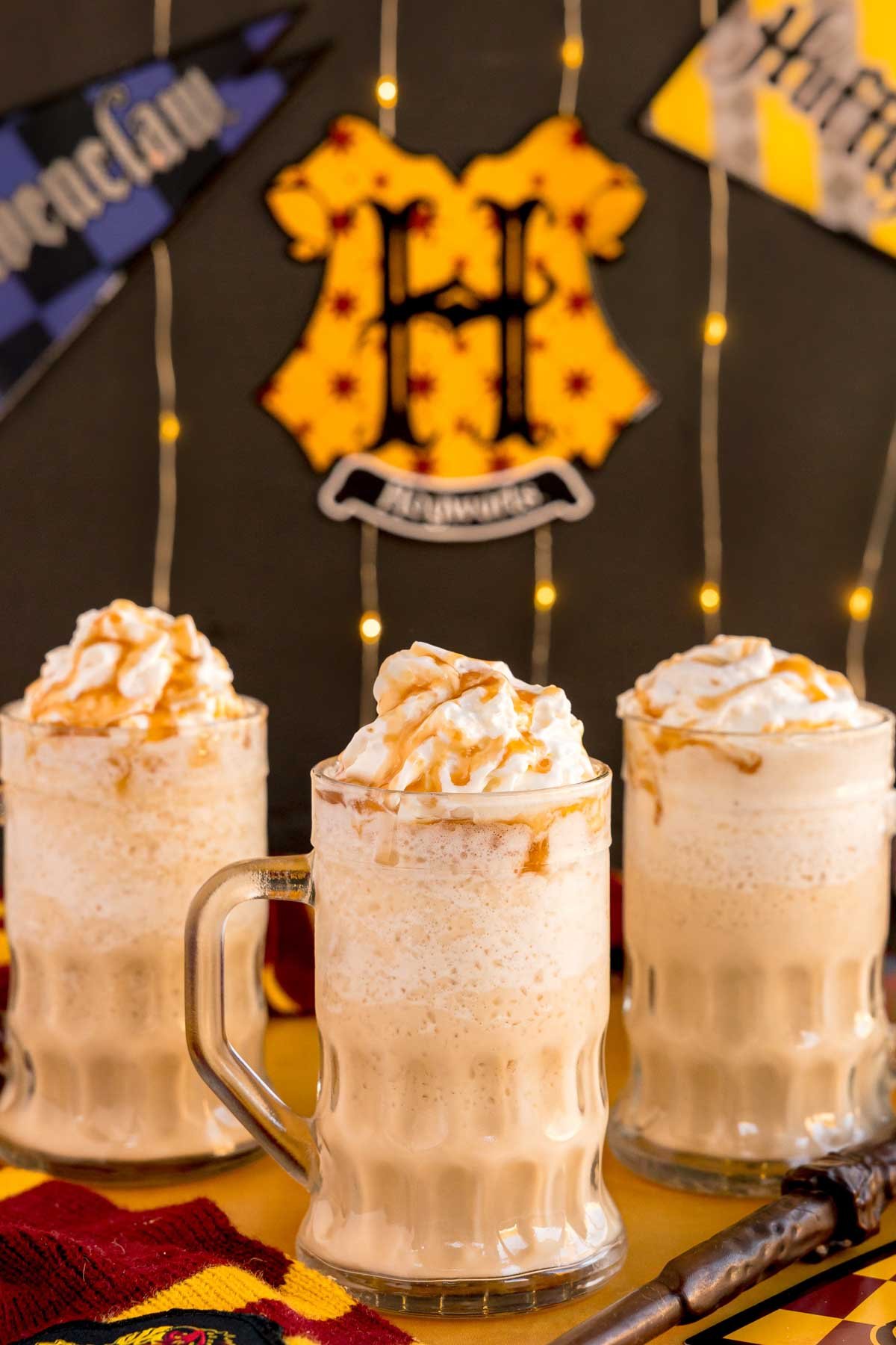 three glass mugs of frozen butterbeer