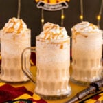 three glass mugs of frozen butterbeer
