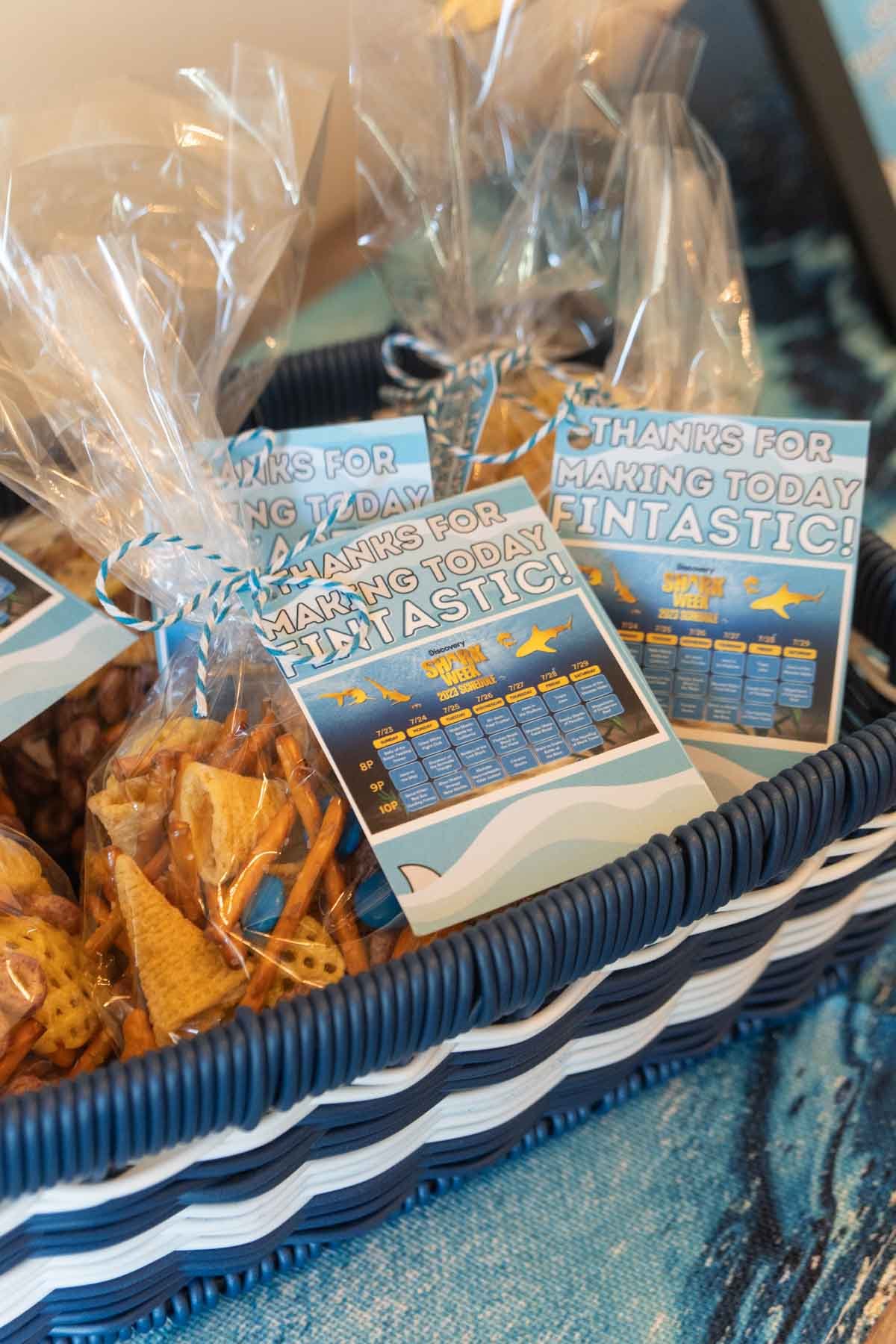 shark snack mix with a gift tag in a blue boat basket