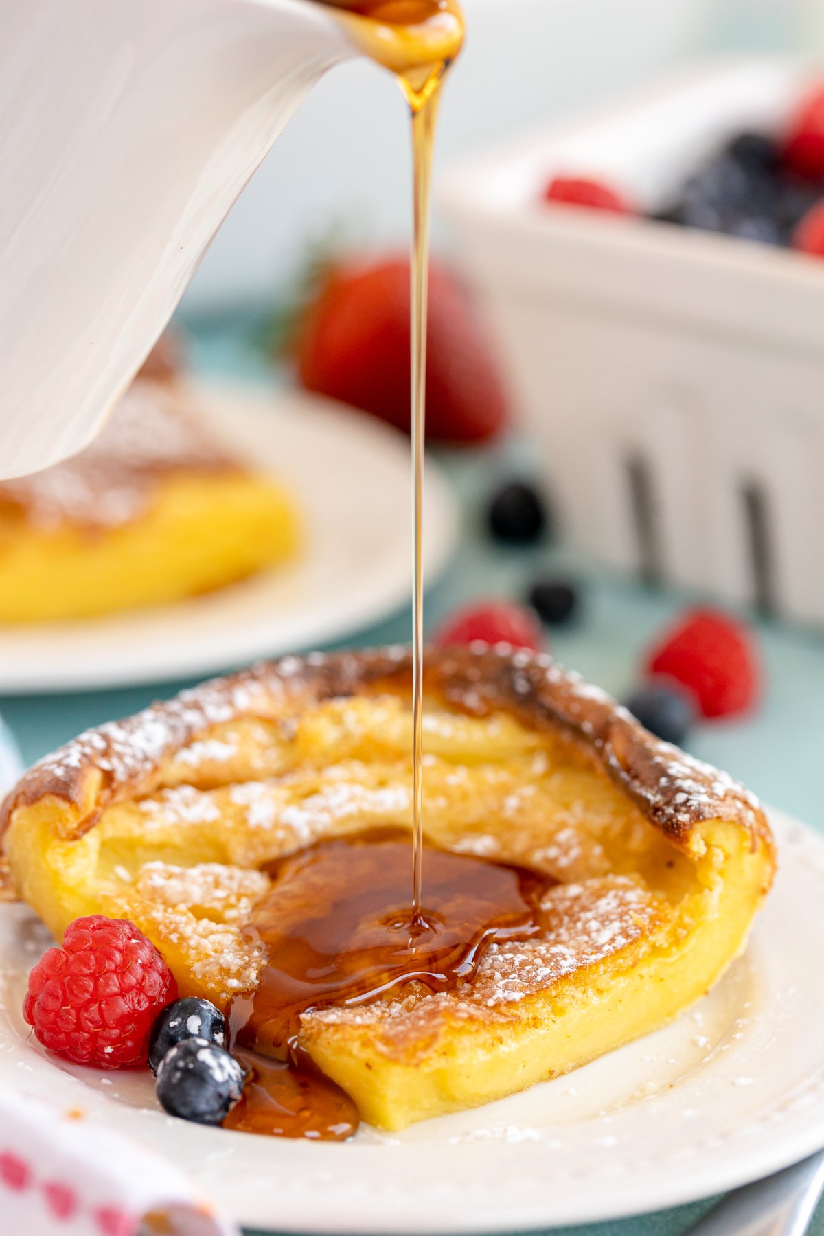 German pancake piece on a white plate with syrup