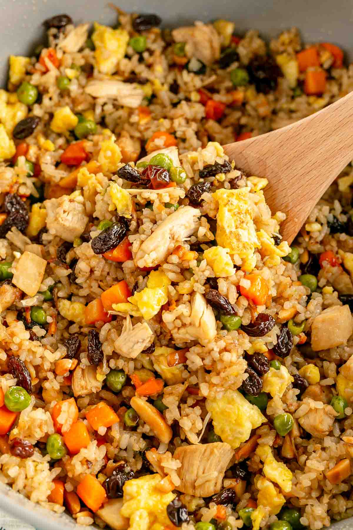 wooden spoon in a pan of rotisserie chicken fried rice