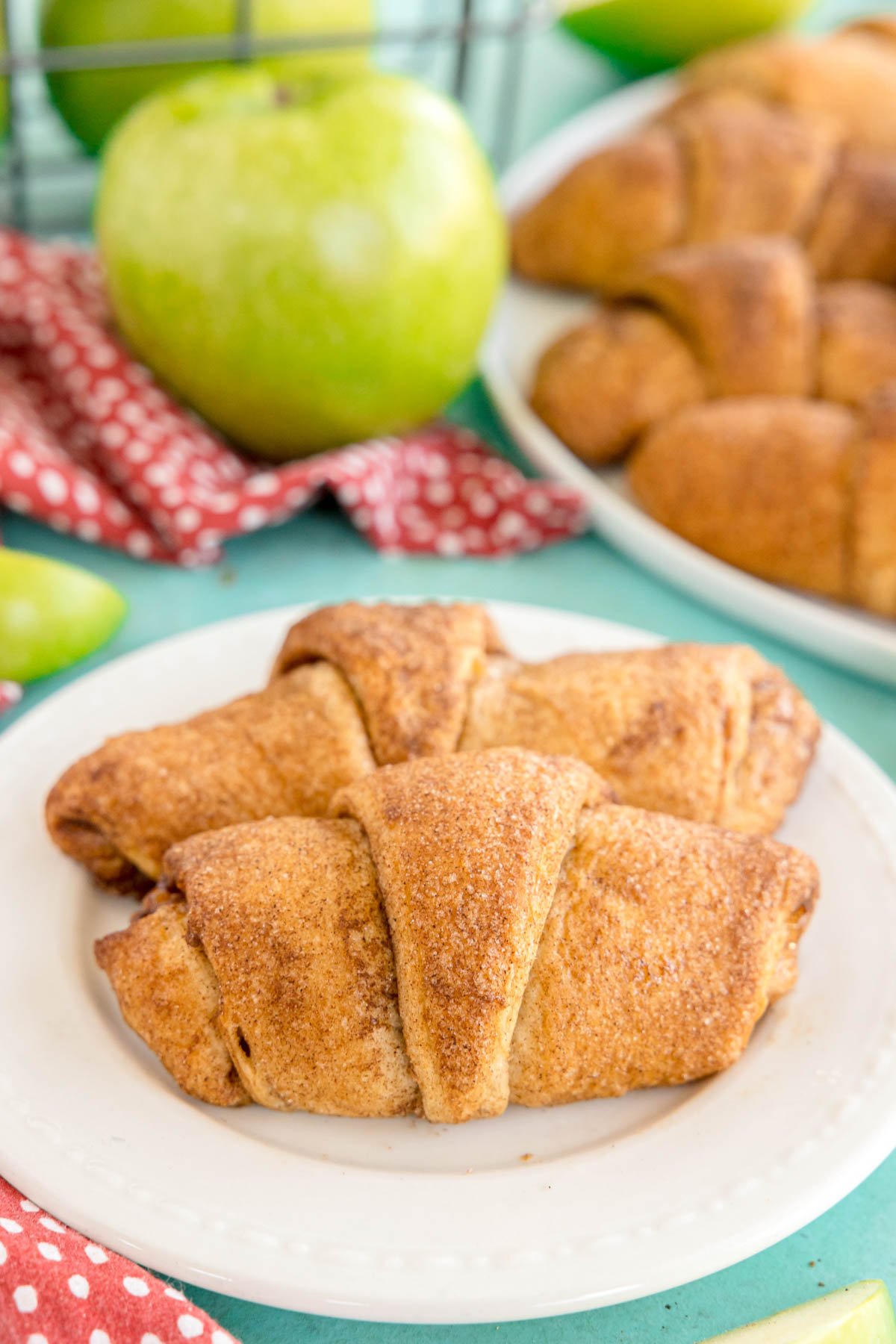 two apple pie turnovers on a white plate