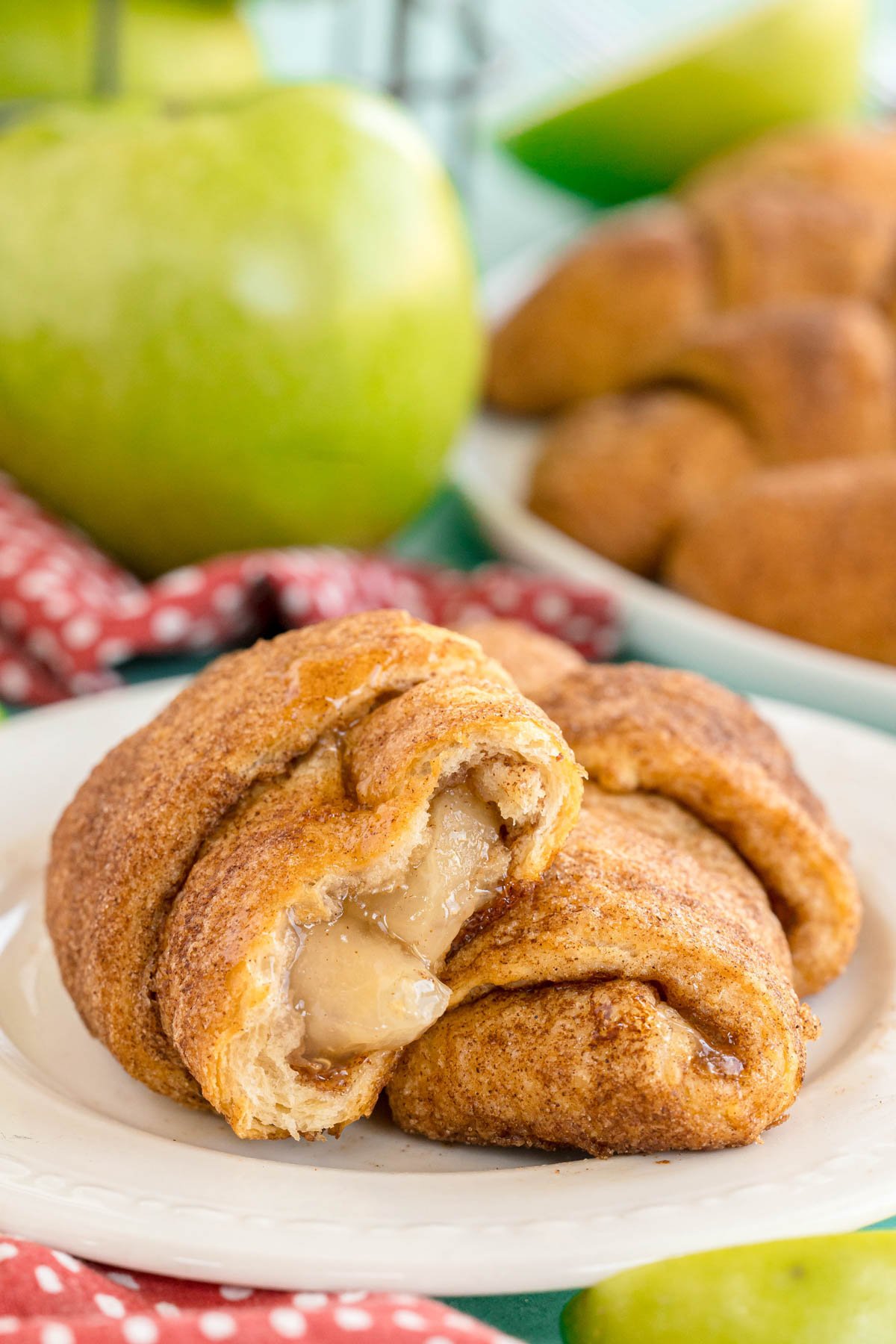 two apple turnovers cut open on a white plate