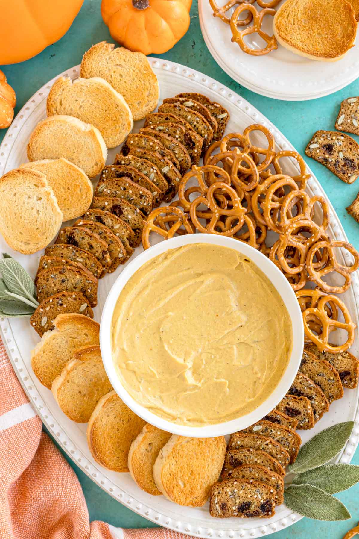 pumpkin goat cheese dip on a white plate with crackers