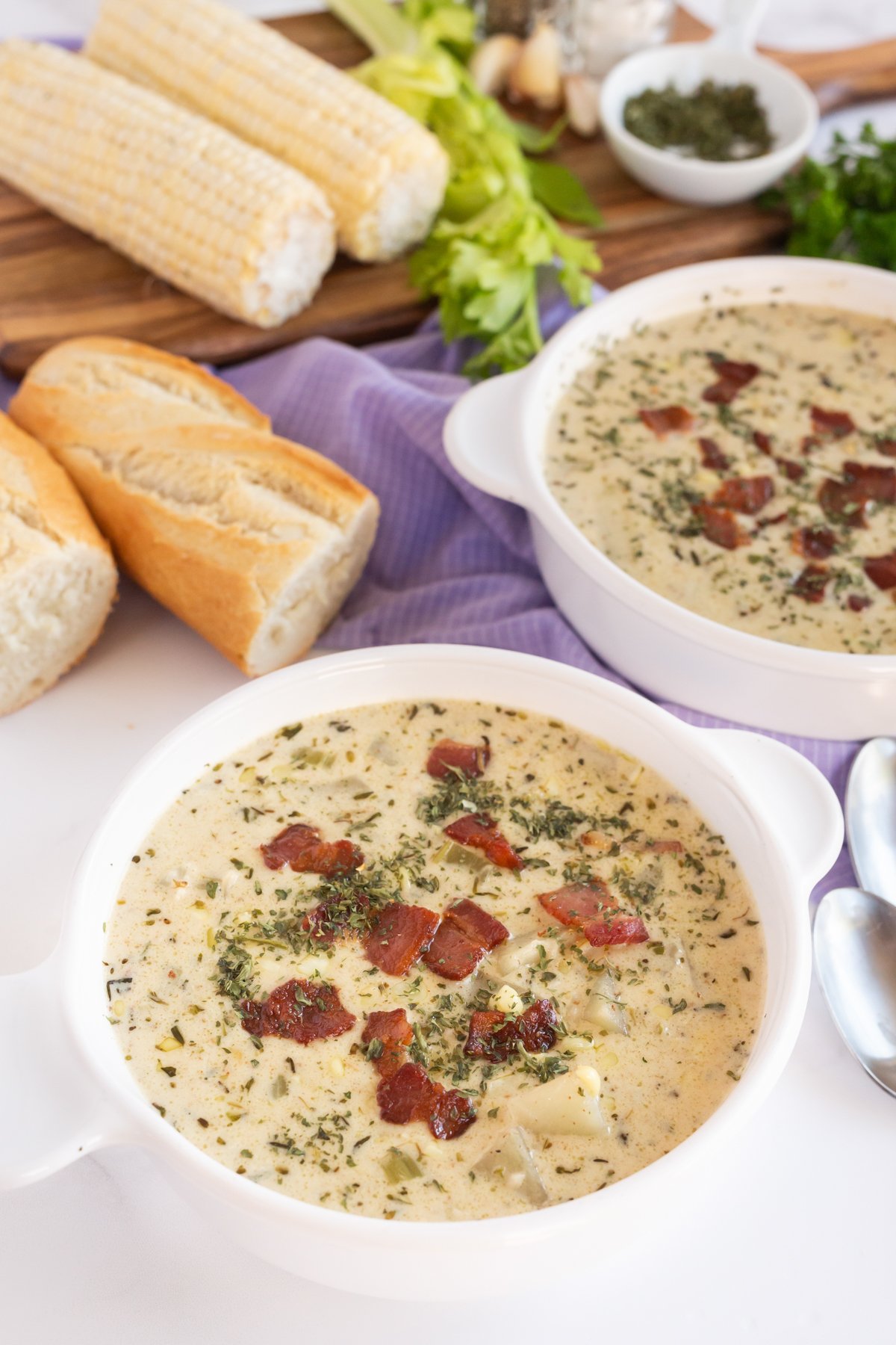 white bowls with corn potato chowder with bacon on top