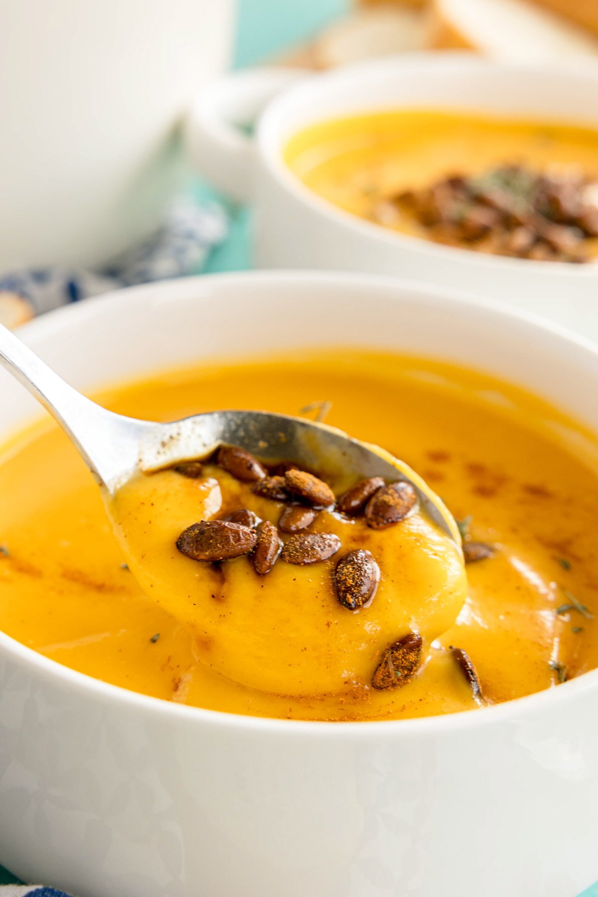 spoon in a bowl of creamy butternut squash soup 