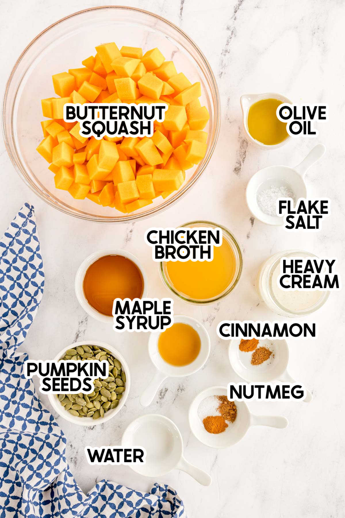 ingredients to make a creamy butternut squash soup with labels