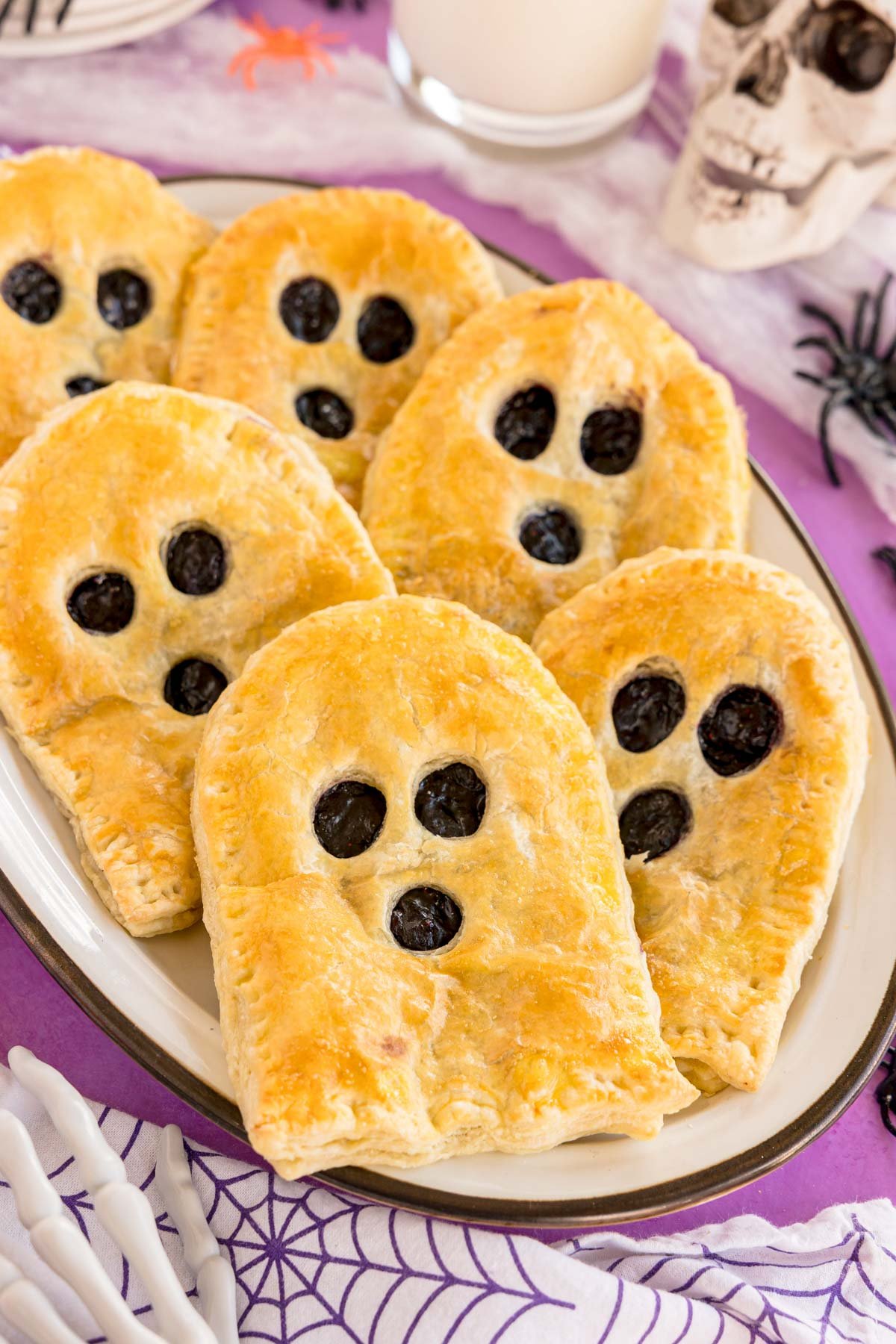 white plate with a bunch of ghost shaped strudels on it