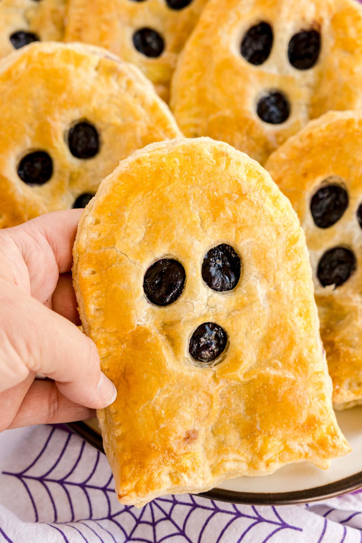 hand holding a ghost shaped strudel