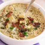 white bowl with potato and corn chowder and a spoon