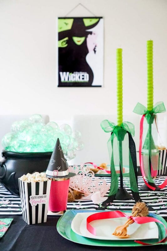 table setting with green and pink, with a sign hanging on the wall in the background