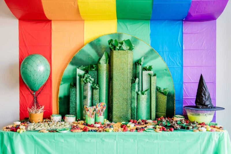 food table with a rainbow background and a green buildings