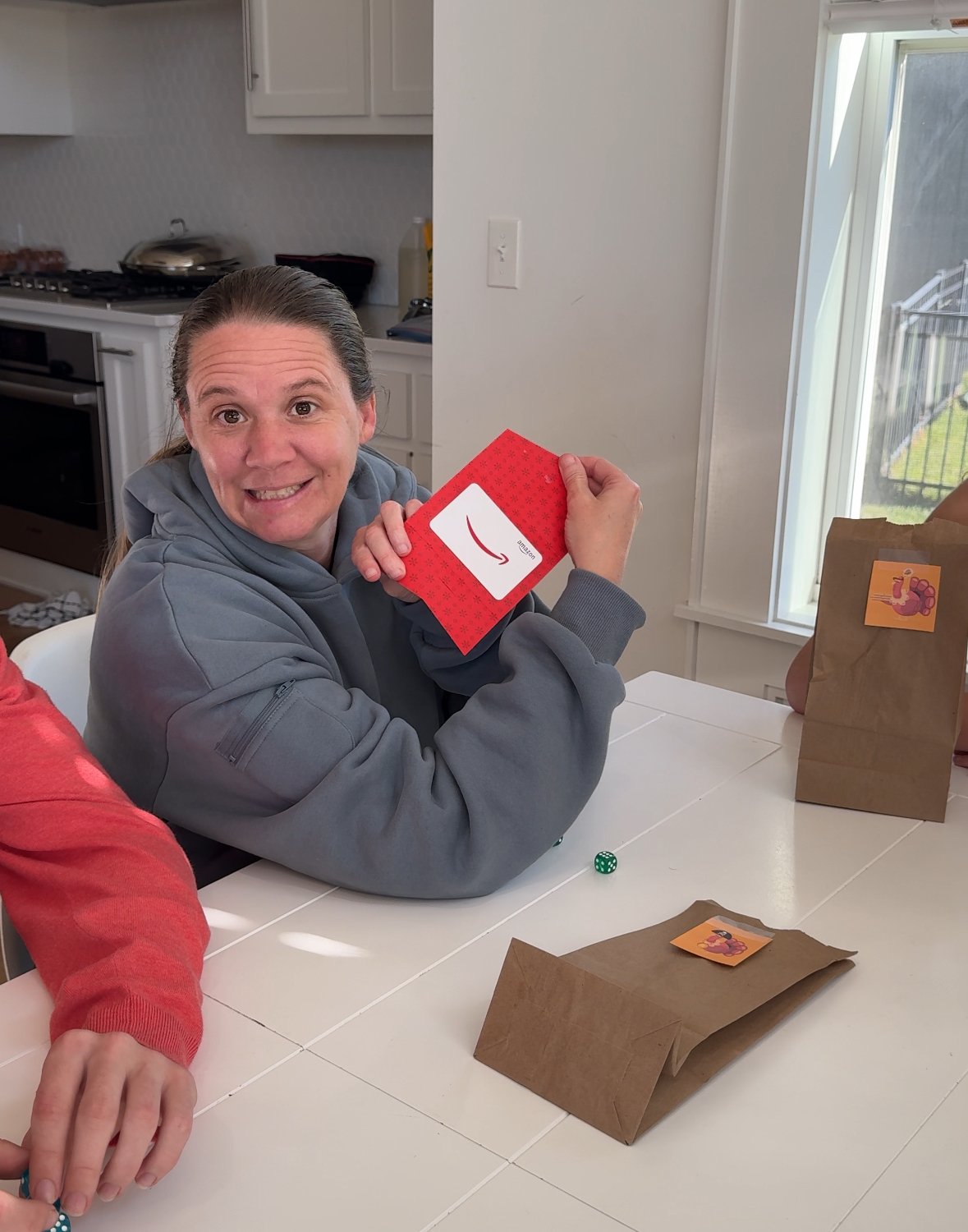 woman holding a red Amazon gift card 