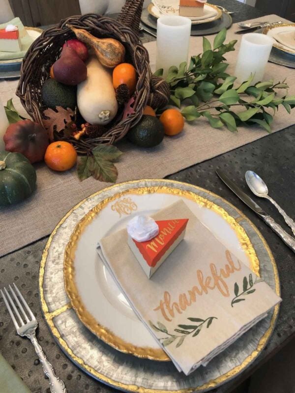 DIY pumpkin pie slice with names on a silver and white plate stack