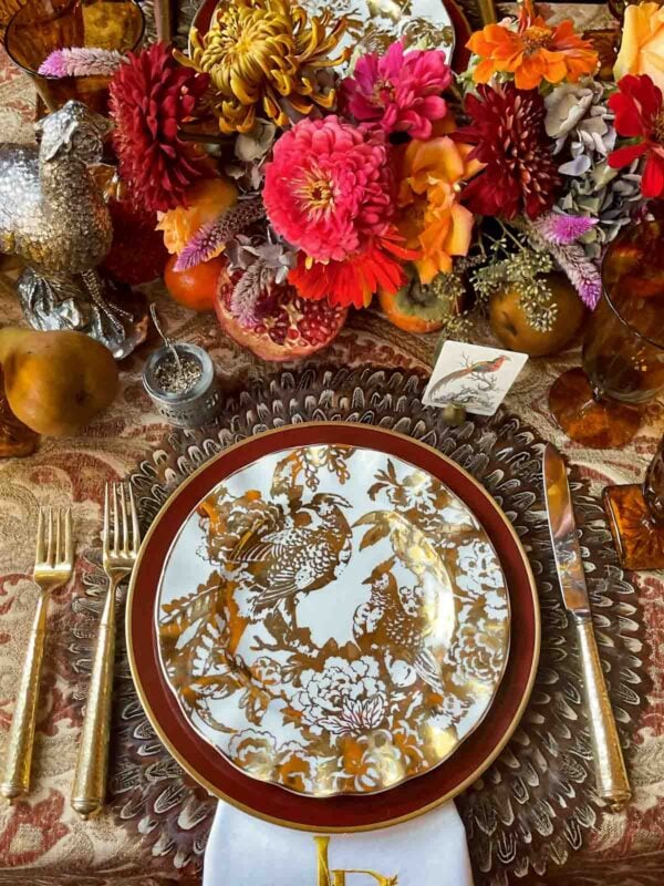 plate decorated with gold birds and floral centerpieces