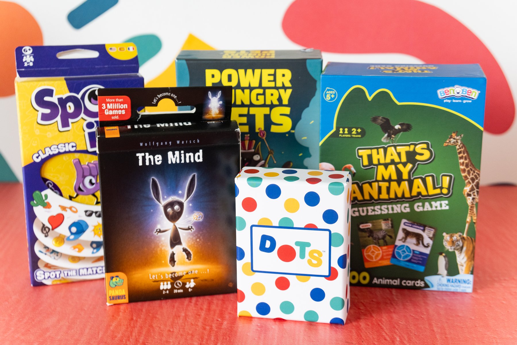 five family card games stacked next to each other